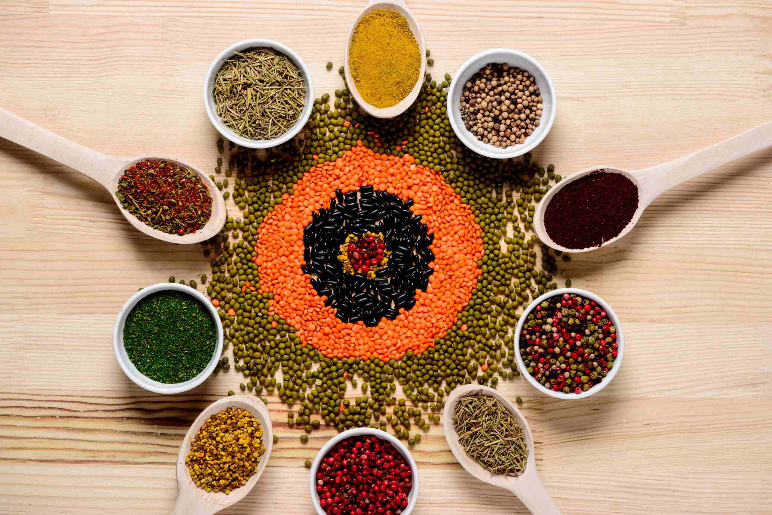 Whole Indian spices on wooden spoons